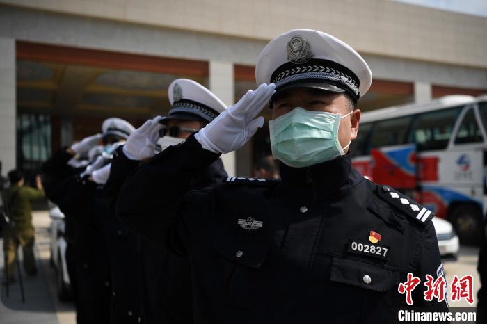 圖為交警們向醫(yī)療隊敬禮?！】灯?攝